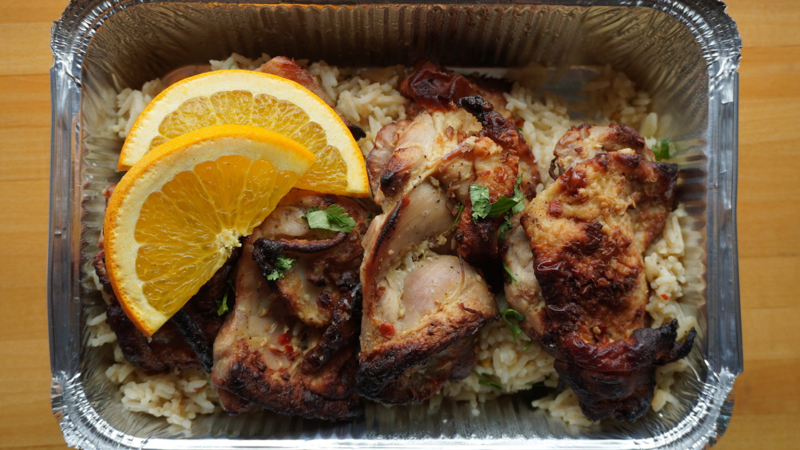 Citrus herb chicken with rice, packed for a group
