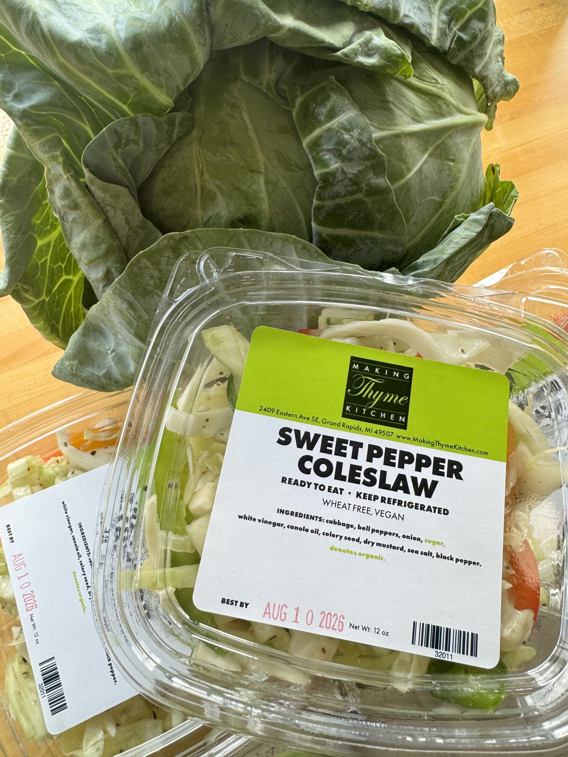 Sweet pepper coleslaw beside a head of cabbage