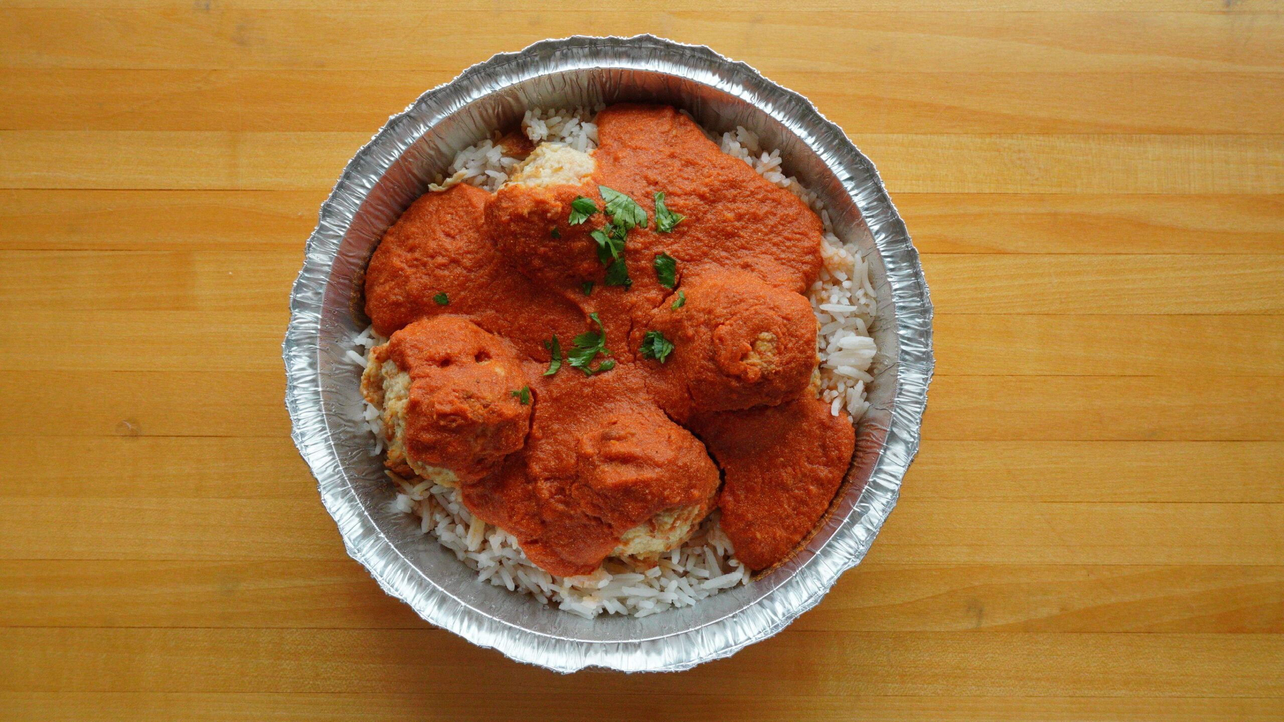 Meatballs in house-made sauce, packed for a group